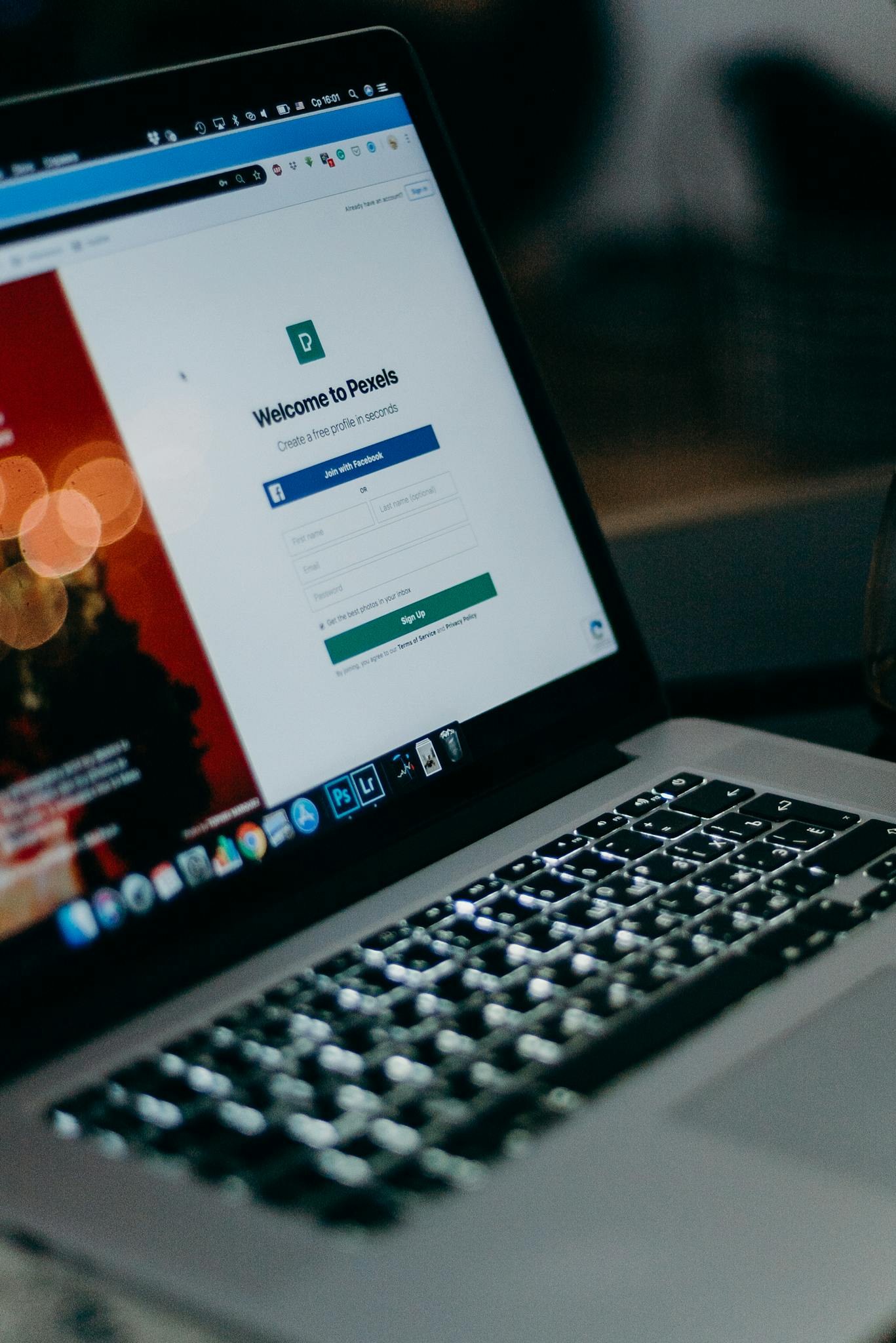 Close-up of a laptop showing the Pexels login interface with a blurred background, creating a moody tech scene.